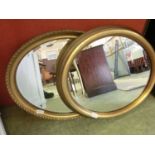 Two gilt framed oval wall mirrors