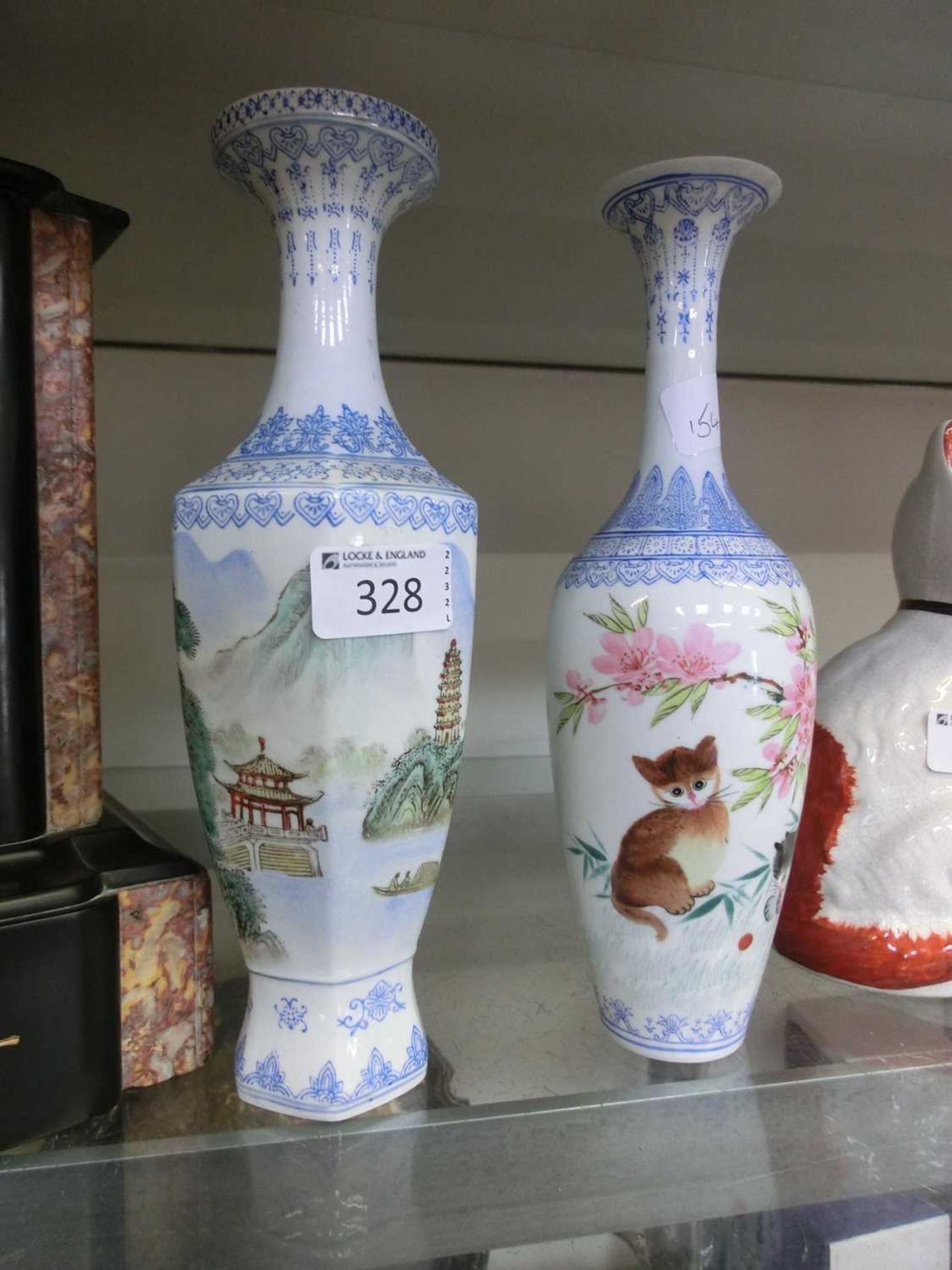 Pair of Asian ceramic vases depicting flowers and animals