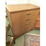 A mid-20th century teak five drawer chest