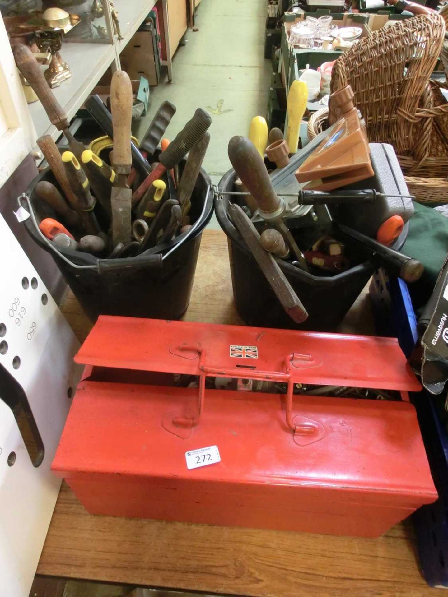 Two buckets containing a number of hand tools together with a red cantilever toolbox with contents