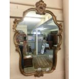 An ornate gilt framed wall mirror