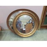 A circular gilt framed wall mirror together with an oval mirror
