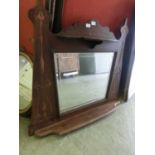 An early 20th century walnut framed over mantle mirror