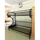 A black tubular metal cabin bed the sofa bed under single bed