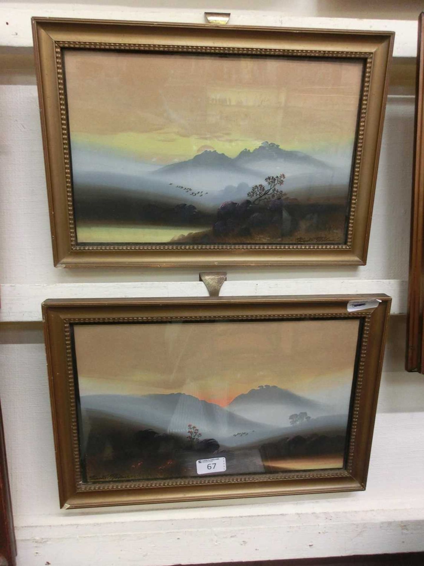 A pair of framed and glazed watercolours of mountain scenes signed by the artist