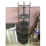 A black metal six tier pot stand