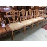 A set of four Ducal dining chairs with plume caved backs