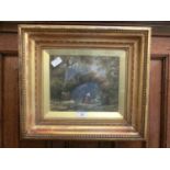 A gilt framed and glazed oil painting of travelling folks cooking scene signed bottom left