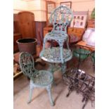 A pale green painted aluminium garden table with two matching chairs
