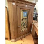 A reproduction stripped pine corner cabinet with mural (dog)
