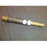 An early 20th century brass and leather three drawer telescope