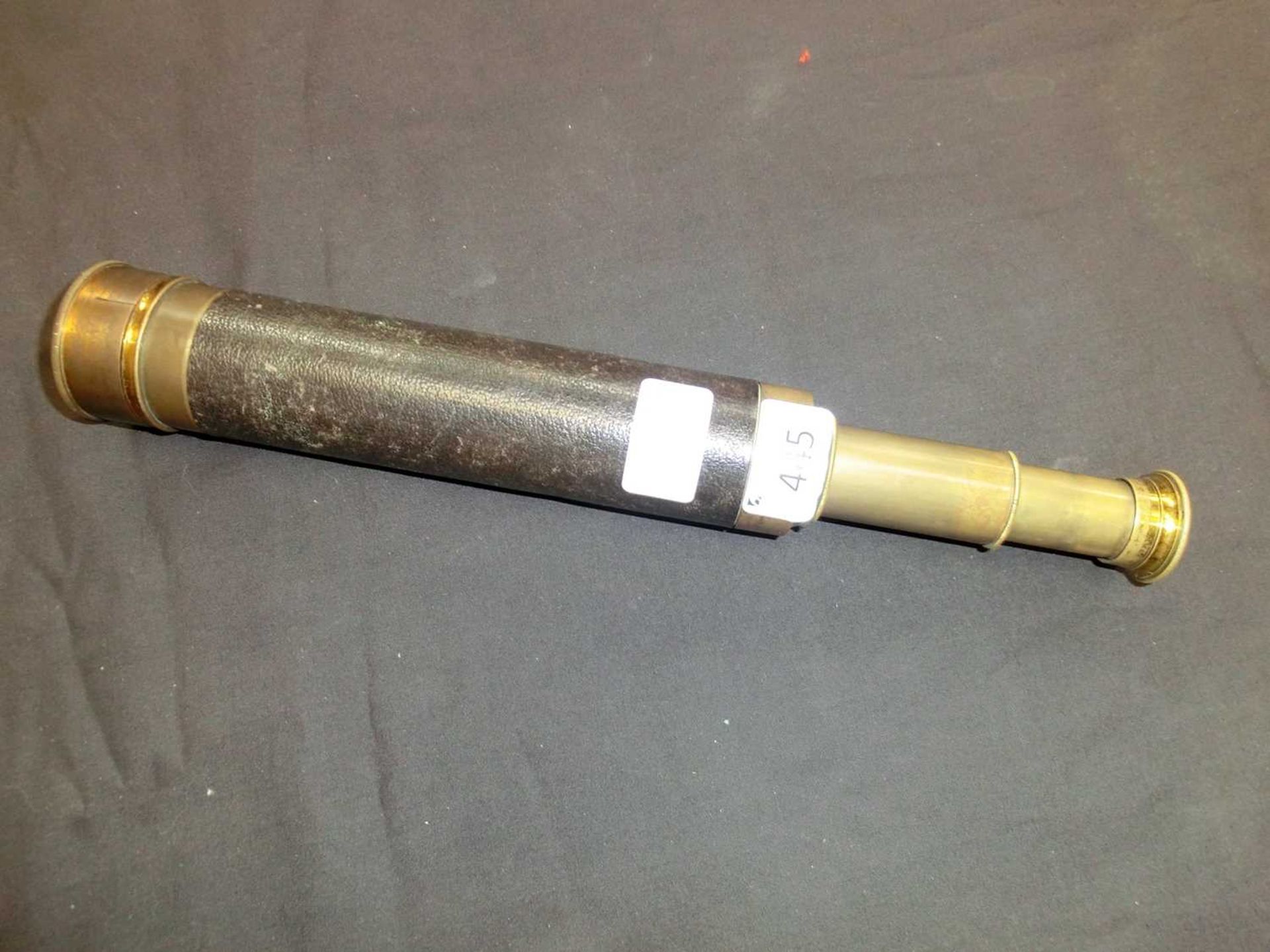 An early 20th century brass and leather three drawer telescope