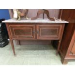 An early 20th century mahogany and satinwood banded marble topped washstand