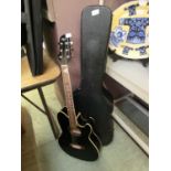 An Ibanez Talmar electro/acoustic guitar with hard case