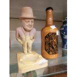 A ceramic ashtray modelled after Winston Churchill together with a Portmeirion bottle