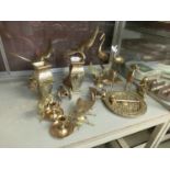 A collection of brass models to include vases, eagles, cannons, etc