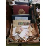 A box containing a large quantity of stamps, some being in albums