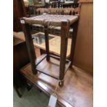 An early 20th century oak framed seagrass seated stool