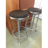 A pair of cast metal bar stools