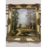 An ornated framed oil on canvas of woodland scene signed bottom right