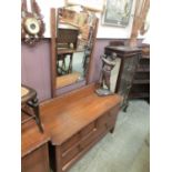 An early 20th century oak dressing chest of two short over one long drawer