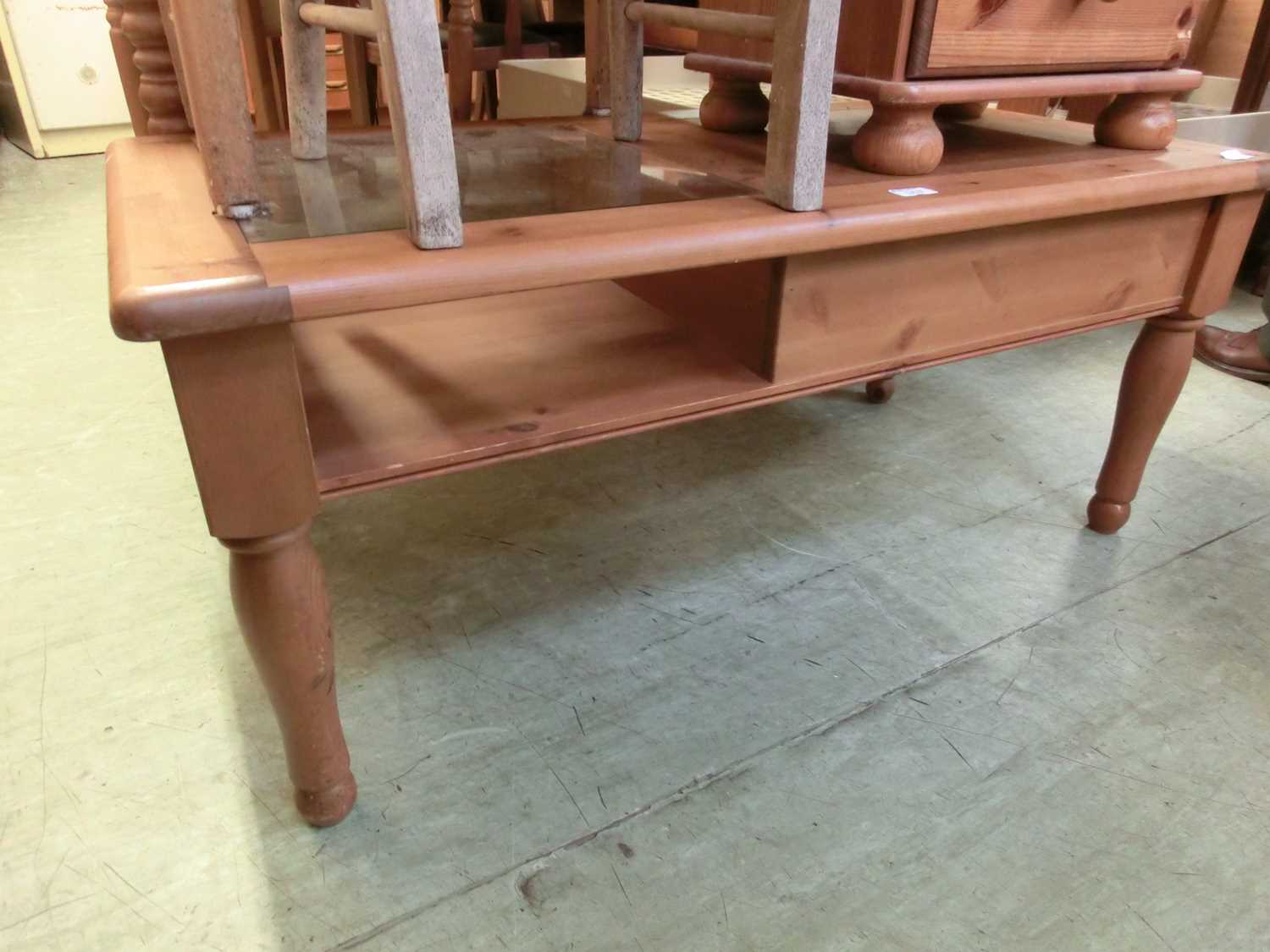 a modern pine coffee table with end drawer and glass top