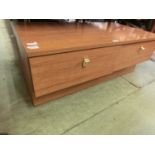 A teak effect two drawer low cabinet