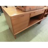 A mid-20th century teak sideboard with drop down cupboard and drawer