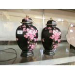 A pair of Carlton ware vases decorated with a floral spray