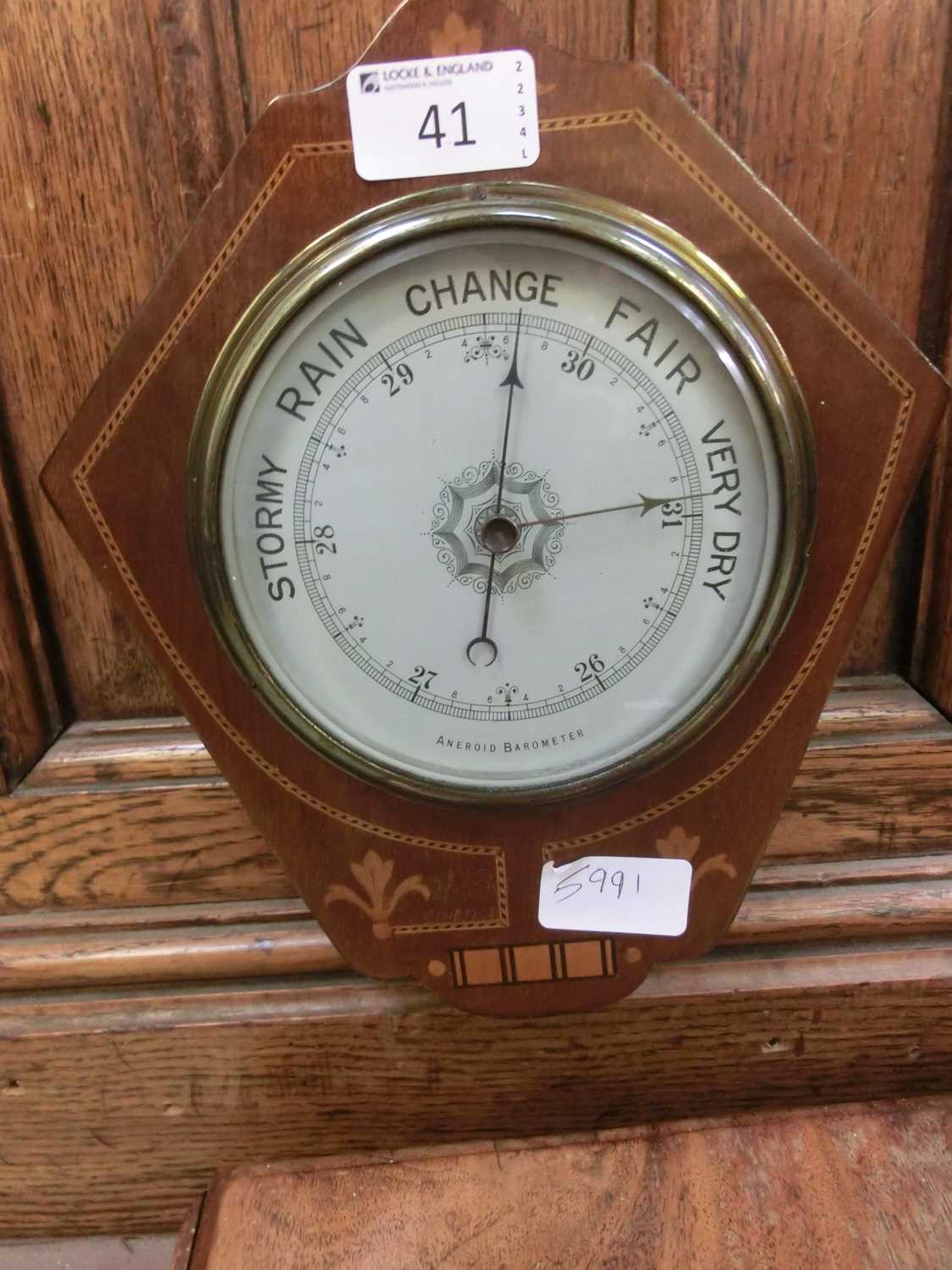 An early 20th century mahogany inlaid aneroid barometer