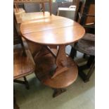 A mid-20th century oak drop coaching style table together with one other