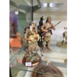 A collection of resin figures of native Americans
