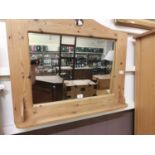 A pine framed wall mirror with shelf