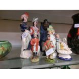 A collection of mainly Staffordshire figurines to include couple, piper, etc