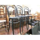 A set of three black painted bentwood style chairs