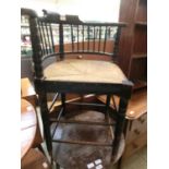 A Victorian ebonised oak corner chair with rush seat and spindle back