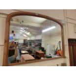 A reproduction pine over mantle mirror