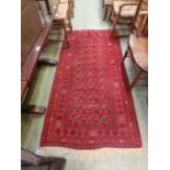 A two metre by one metre rectangular oriental rug with a red ground