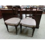A pair of Edwardian single chairs with carved and pierced top rail and splat on turned legs