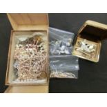 A box containing a collection of costume jewellery