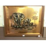 A copper plated resin relief artwork of elephants signed Lindiwe