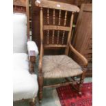 A Victorian beech and rush seat rocking chair