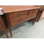 An Edwardian mahogany chest of two short over one long drawer