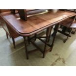 An early 20th century oak drop leaf table with barley twist supports