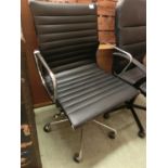 A chrome framed and black vinyl open arm office chair