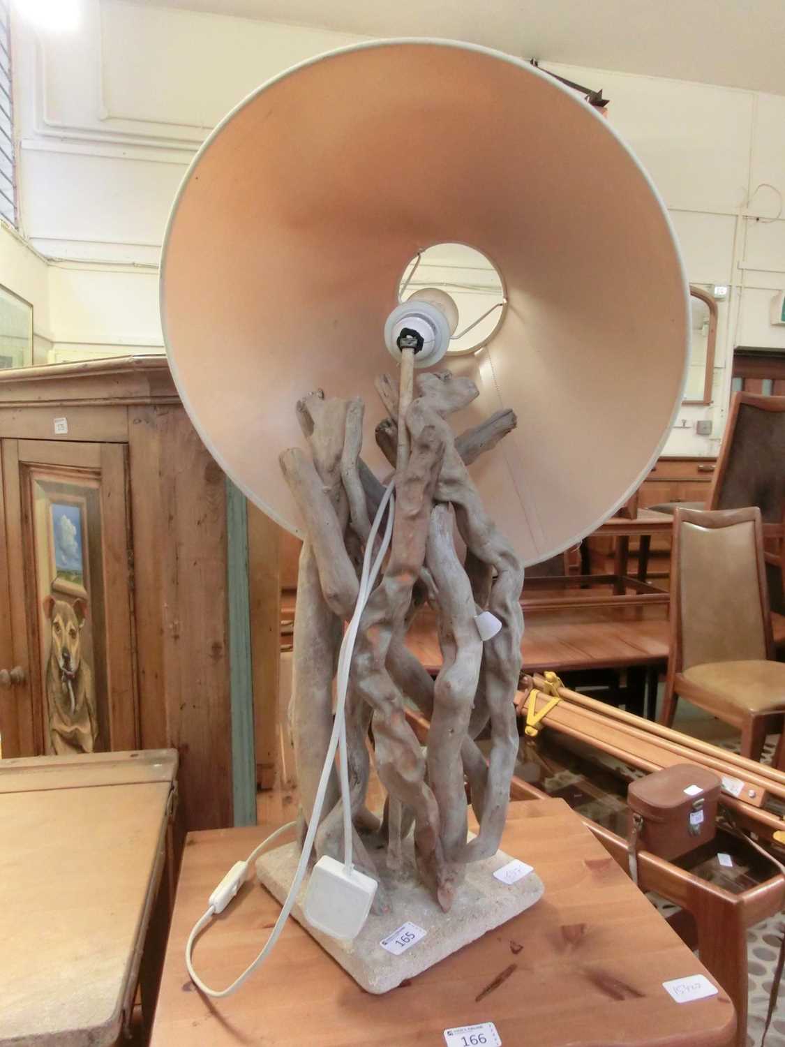 A driftwood lamp base with shade