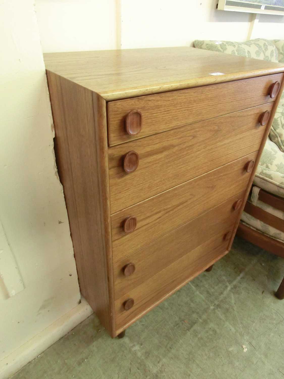 A mid-20th century teak chest of five drawers