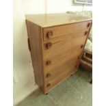 A mid-20th century teak chest of five drawers