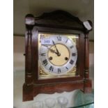 An early 20th century brass dial oak cased striking mantle clock