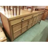 A mid-20th century teak sideboard with three cupboards and three drawersMinor knocks and scratches